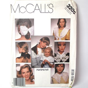 May include: A vintage McCall's sewing pattern envelope with the number 3205 printed on the front. The pattern is for a lace collar and features several different styles of collars on the front of the envelope.