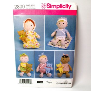 May include: Simplicity sewing pattern number 2809 for making a doll. The pattern includes instructions for making a doll with a yellow and white dress, a doll with a blue and white outfit, a doll with a pink and white outfit, and a doll with a pink and white dress. The pattern also includes instructions for making a small stuffed animal.