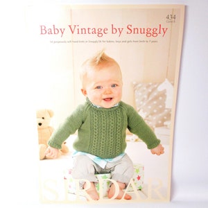 May include: A baby wearing a green knitted sweater with a cable stitch pattern. The sweater is from the "Baby Vintage by Snuggly" knitting pattern book, code B 434.