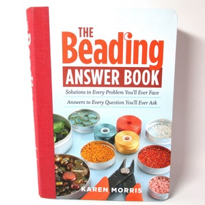 May include: A book titled "The Beading Answer Book" with a red spine. The cover features the title in orange, with the subtitle "Solutions to Every Problem You'll Ever Face". Various beads and tools are pictured.