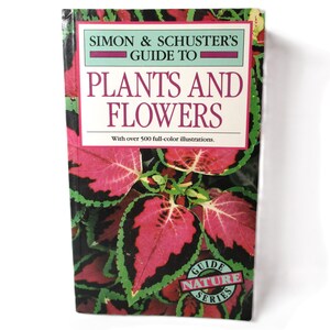 May include: A book titled "Simon & Schuster's Guide to Plants and Flowers" with over 500 full-color illustrations. The cover features a close-up of a pink and green leafy plant.