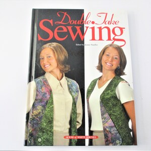 May include: Book cover with the title "Double Take Sewing" in red text. Two women are featured on the cover, each wearing a different patterned vest. The book is published by House of White Birches.