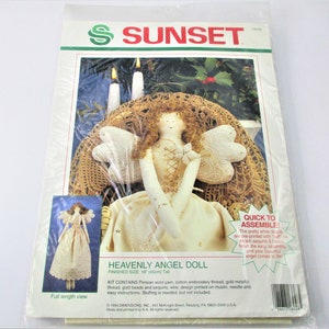 May include: A craft kit for making a white angel doll with gold accents. The kit includes Persian wool yarn, cotton embroidery thread, gold metallic thread, gold beads and sequins, wire, a design printed on muslin, a needle, and easy instructions. The finished doll is 18 inches tall.  Stufing is needed, but not included.