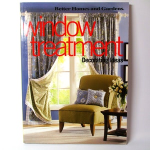 May include: A book titled "Window Treatment Decorating Ideas" by Better Homes and Gardens, featuring a photo of a living room with a window, curtains, and a chair.
