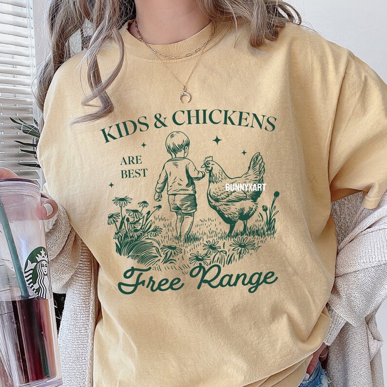 May include: A yellow t-shirt with a green graphic design that says "Kids & Chickens Are Best Free Range". The graphic features a child and a chicken.