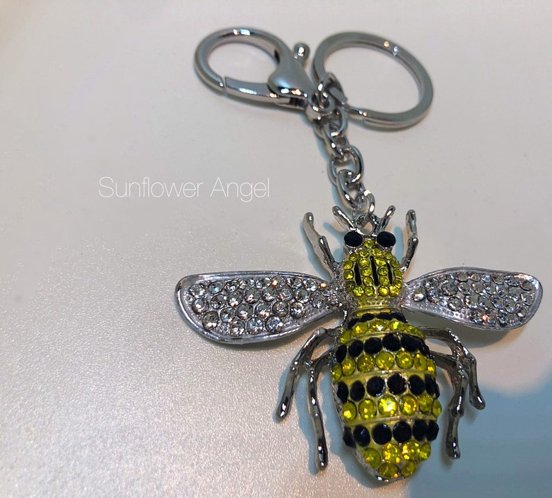 in silver with ring and bag clip. Large bumble Queen bee diamante keyring or bag charm