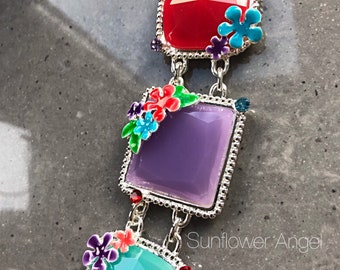 Silver plated bracelet, with acrylic squares and enamel flowers.