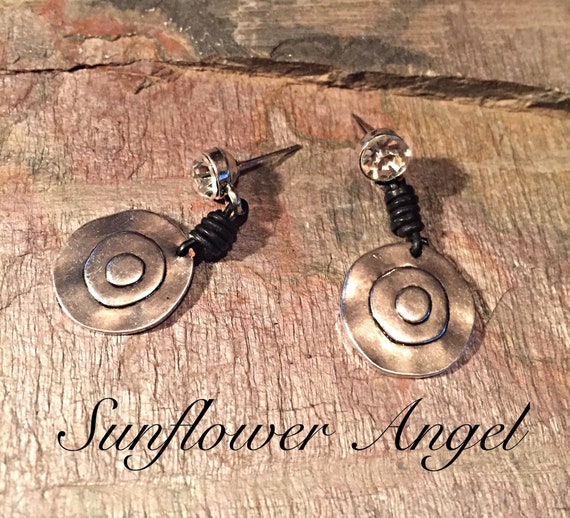 Earrings, with diamante stud, with metal built up disc, joining with black leather wrap around