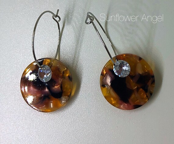 Acrylic earrings. With a loose crystal, hoop for pierced ears.