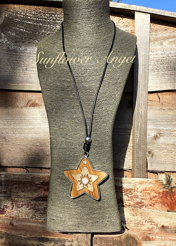 Super, Large wooden star pendant on long black leather thread.