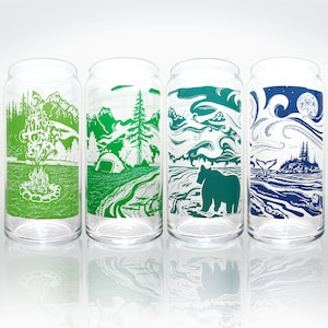 Peut inclure: Quatre verres en verre transparent avec des motifs sur le thème de la nature en vert, bleu et blanc. Les motifs comprennent un feu de camp, une forêt, un ours et une baleine.