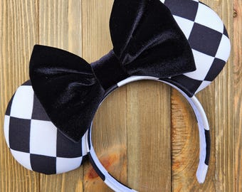 May include: Black and white checkered mouse ears with a black velvet bow.