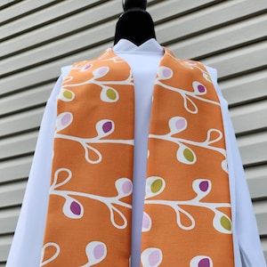 Modern orange clergy stole with funky flowers. Reversible with lavender backing for minister, pastor, priest or wedding officiant