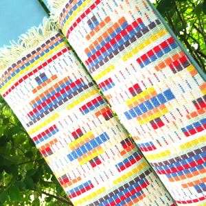 Light green clergy stole with upcycled woven vintage geometric rainbow design for ordinary time