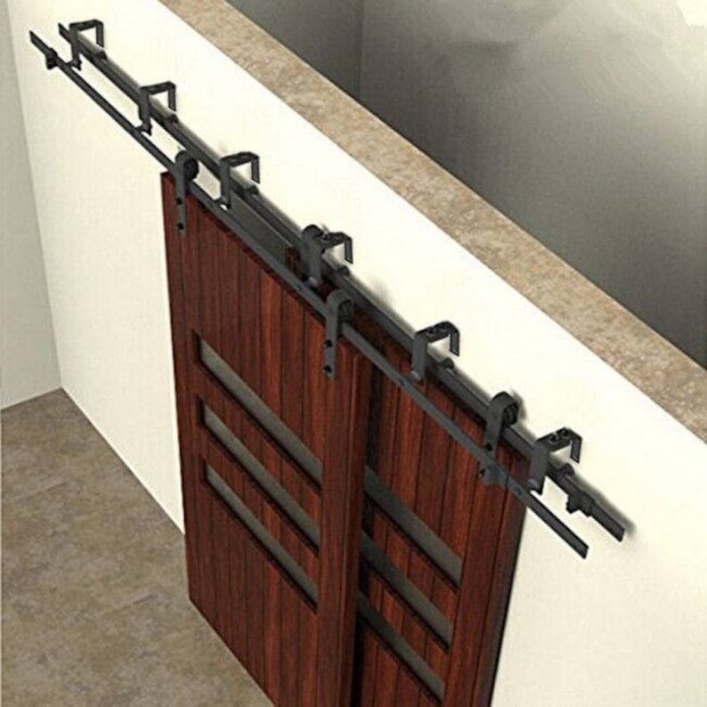 May include: A double sliding barn door system with black metal hardware and two wooden doors with glass panels. The doors are a rich mahogany color.