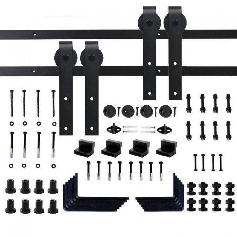 May include: Black sliding barn door hardware kit with two rollers, two door handles, two track pieces, and various mounting hardware. The kit includes screws, brackets, and an Allen wrench.