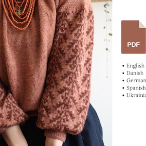 May include: A brown knitted jumper with a geometric pattern on the sleeves. The jumper has a loose fit and a round neckline.