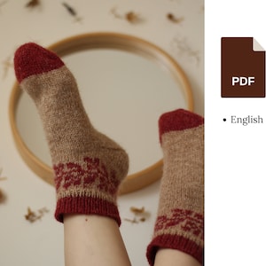 May include: A pair of knitted socks with a brown and red pattern. The socks are made with a soft, fuzzy yarn. The socks are shown on a person's feet.