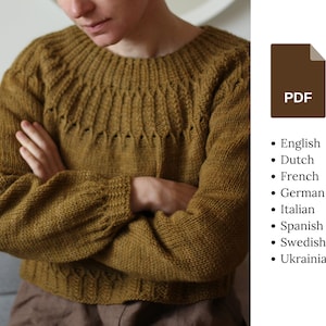 May include: A brown knitted jumper with a cable knit pattern. The jumper has a crew neck and long sleeves.