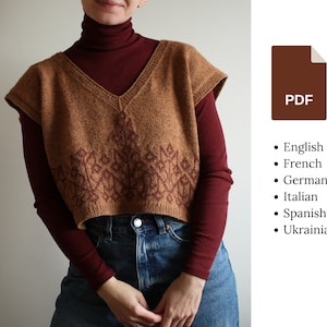 May include: A brown knitted sleeveless sweater vest with a burgundy patterned design. The vest has a V-neck and is cropped. The model is wearing the vest over a burgundy turtleneck shirt and blue jeans. The image also includes a brown PDF icon and a list of languages: English, French, German, Italian, Spanish, and Ukrainian.