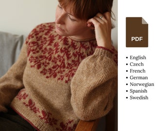 May include: A brown knitted jumper with a red floral pattern. The jumper has long sleeves and a round neckline.