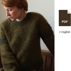 May include: A green and brown knit sweater with a crew neck and long sleeves. The sweater has a subtle pattern and a relaxed fit.