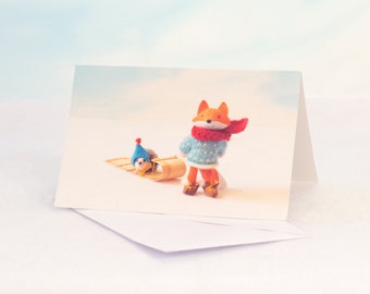 One blank greeting card of Fox and Hedgehog sledding