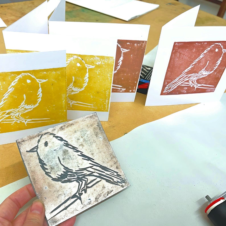 example lino printing - a robin single colour print with copper and gold