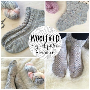 May include: A pair of grey and white speckled knitted socks with a chevron pattern. The socks are shown on a white furry surface. The yarn used to knit the socks is shown in a separate image.