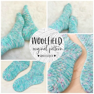 May include: A pair of teal blue and white speckled knit socks with a diamond pattern. The socks are laid out on a white fuzzy surface. The image includes the text "WOOLFIELD original pattern" and "WOOLFIELD.CA".