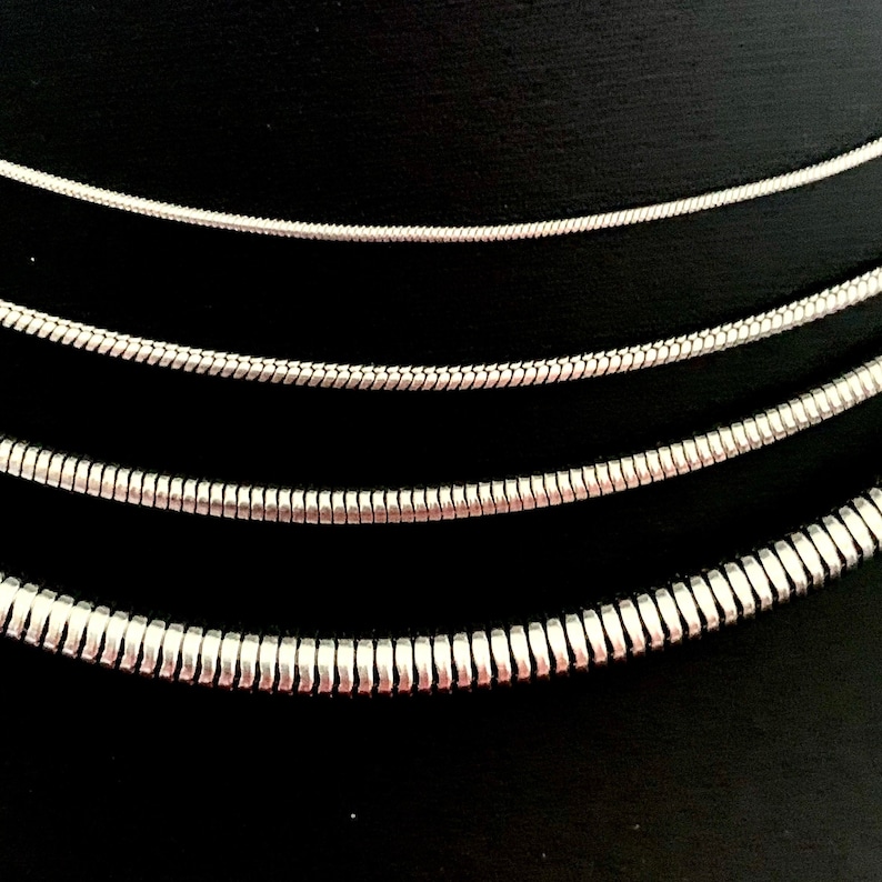 Snake Chain Necklace design in silver color made of 316L Stainless Steel.  Great wearing with no tarnishing. Nice for gift giving for Men or Women. Widths include 1mm, 1.5mm, 2.4mm and 4mm.
