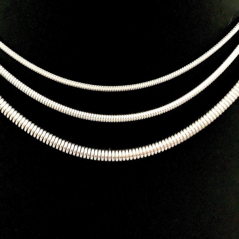 Snake Chain Necklace design in silver color made of 316L Stainless Steel.  Great wearing with no tarnishing. Nice for gift giving for Men or Women. Widths include 1mm, 1.5mm, 2.4mm and 4mm.