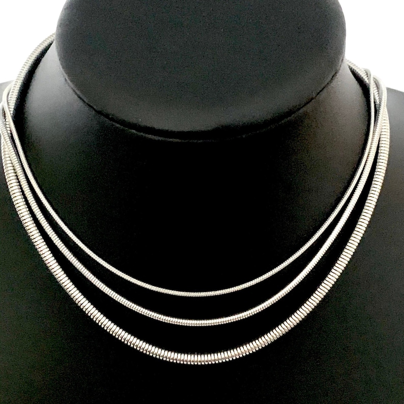 Snake Chain Necklace design in silver color made of 316L Stainless Steel.  Great wearing with no tarnishing. Nice for gift giving for Men or Women. Widths include 1mm, 1.5mm, 2.4mm and 4mm. Perfect Gift for Men or Women