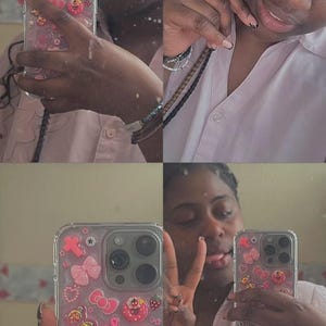 May include: Clear phone case decorated with pink bows, hearts, stars, and a Hello Kitty figure. The case is on a phone with multiple camera lenses. The person in the image is wearing a pink shirt.