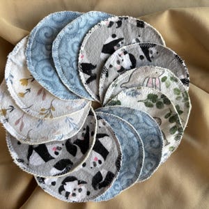 May include: A set of 14 reusable makeup remover pads in a variety of patterns. The pads are made of soft, absorbent fabric and are designed to be gentle on the skin. The patterns include floral designs, panda bears, and swirls.