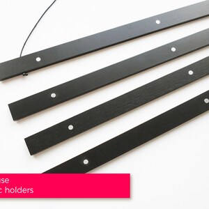 May include: Four black wooden rods with silver magnetic holders. Easy to use magnetic holders.