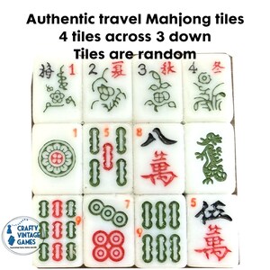 May include: A set of twelve white Mahjong tiles arranged in a four-by-three grid. Each tile features engraved symbols, characters, and numbers in red, green, and black ink. The text Authentic travel Mahjong tiles 4 tiles across 3 down Tiles are random appears above the tiles.