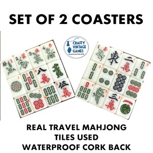 May include: A set of two square coasters featuring arrangements of white mahjong tiles with green, red, and black engraved characters and symbols. The text SET OF 2 COASTERS and REAL TRAVEL MAHJONG TILES USED WATERPROOF CORK BACK is visible.