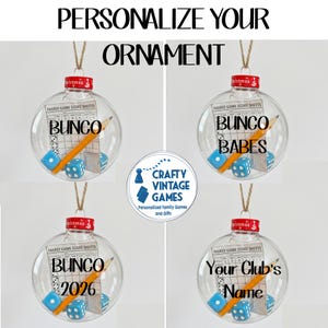 May include: Four clear, spherical, hollow Christmas ornaments, each containing a yellow pencil, two blue dice, and a printed family game score sheet. The red caps feature the word Christmas. Text on the ornaments includes Bunco, Bunco Babes, Bunco 2026, and Your Club's Name. A central logo reads Crafty Vintage Games.