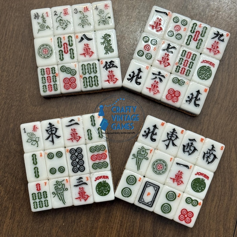 May include: Four square arrangements of white Mahjong tiles featuring various red, green, and black engraved symbols, characters, and numbers. Each tile displays distinct traditional markings including bamboo, circles, winds, dragons, and joker labels.