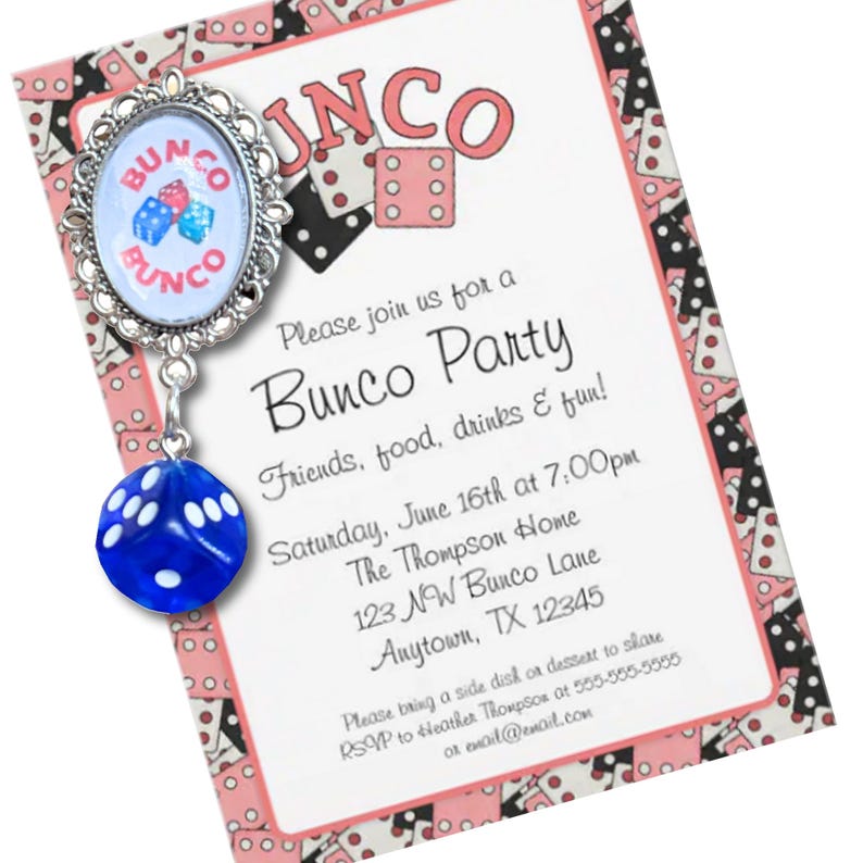 May include: A silver-toned oval brooch featuring a graphic of three dice and the text BUNCO, with a dangling blue die charm. The brooch is displayed on a rectangular invitation card with a pink and black dice pattern and printed party details.
