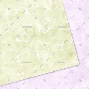 May include: Two seamless patterns featuring a watercolour background with white butterfly silhouettes. The first pattern is on a light green background and the second pattern is on a light purple background.