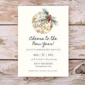 May include: New Year's Eve invitation with a watercolor design. The invitation features a gold glitter ball with green sprigs and red berries. Text reads "Cheers to the New Year!" and details the date, time, and location.