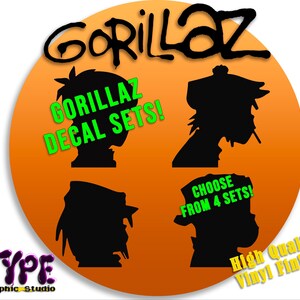 May include: A set of four Gorillaz decal sets. The decals feature black silhouettes of the band members on an orange background. The text "Gorillaz Decal Sets!" and "Choose from 4 sets!" is written in green. The text "High Quality Vinyl Finish!" is written in white.