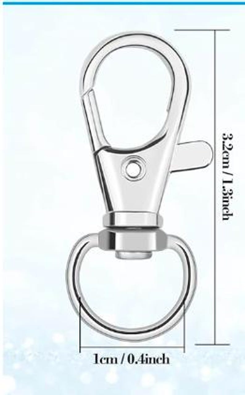 May include: A silver-colored metal lobster claw clasp with a swivel base and a circular ring attachment. The clasp measures 1.3 inches in total length, and the circular ring has a diameter of 0.4 inches as indicated by the visible measurement lines.
