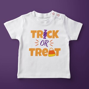 May include: White baby onesie with the text "Trick or Treat" in orange and yellow letters. A purple candy and a yellow and orange candy corn are included in the design.