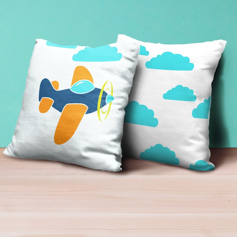 May include: Two white pillowcases with blue clouds and a blue and orange aeroplane on one pillowcase.