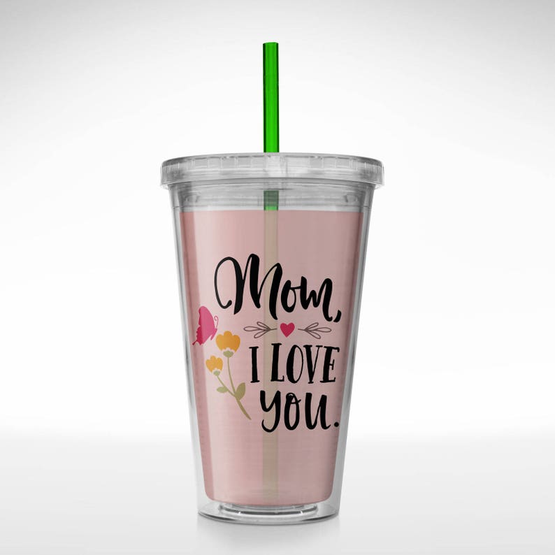 May include: A clear plastic tumbler with a pink background and a black design that says "Mom, I love you." The design also includes a butterfly, a heart, and flowers. The tumbler has a green straw.