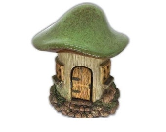 May include: A small ceramic mushroom house with a green roof, a brown door, and a stone base. The house has two small windows on each side.
