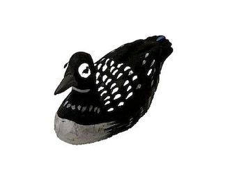 May include: Black and white loon bird figurine with a blue beak. The figurine is made of wood and has a detailed design.